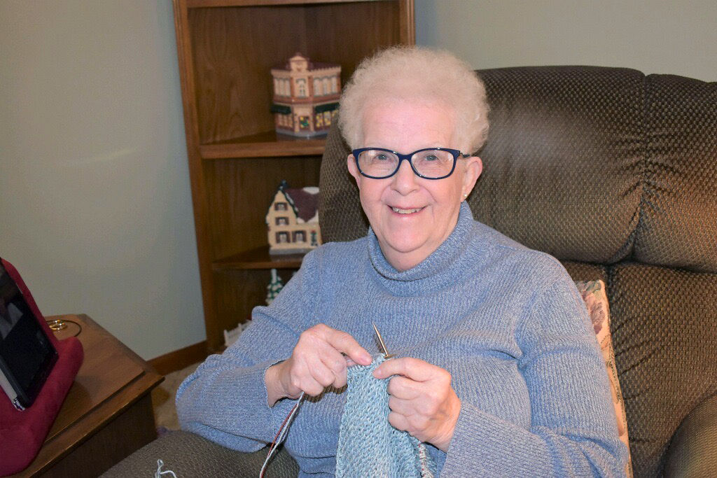 Mary Waltman works on a sleeve for a sweater